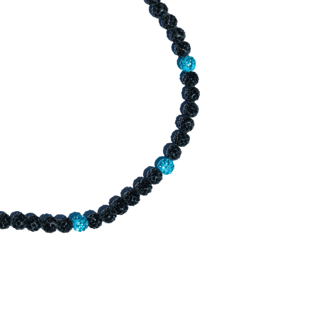 Necklace with black and blue beads on a white background