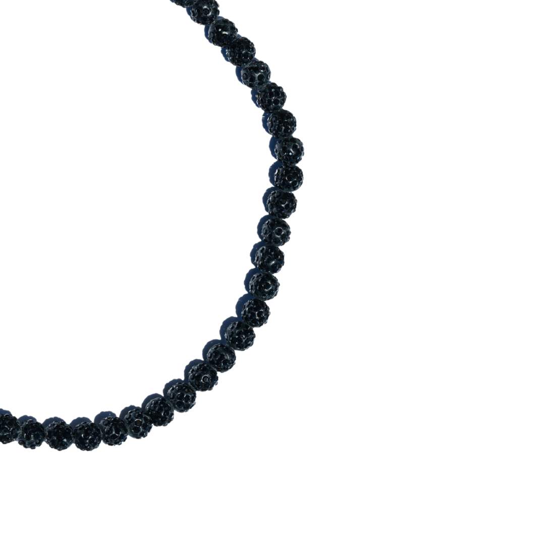Necklace with black beads on a white background