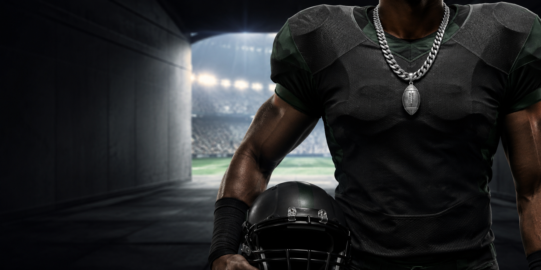 Football player wearing a Cuban-link chain and football pendant in a stadium tunnel