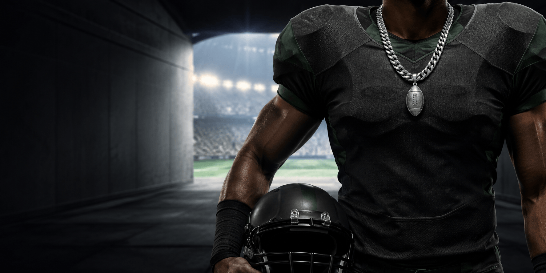 Football player wearing a Cuban-link chain and football pendant in a stadium tunnel