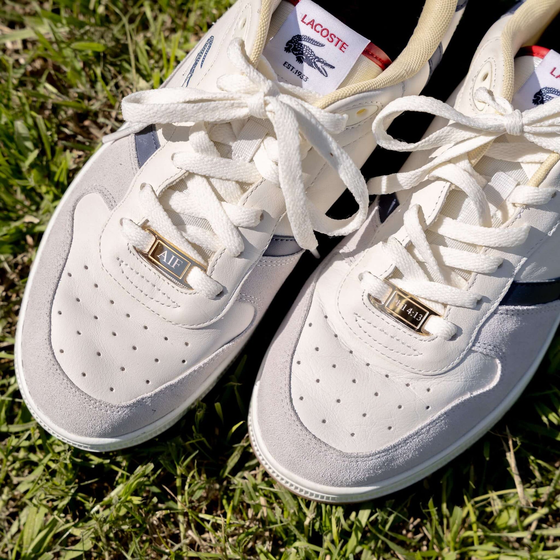 White sneakers with gold customizable AF1 shoe tags 