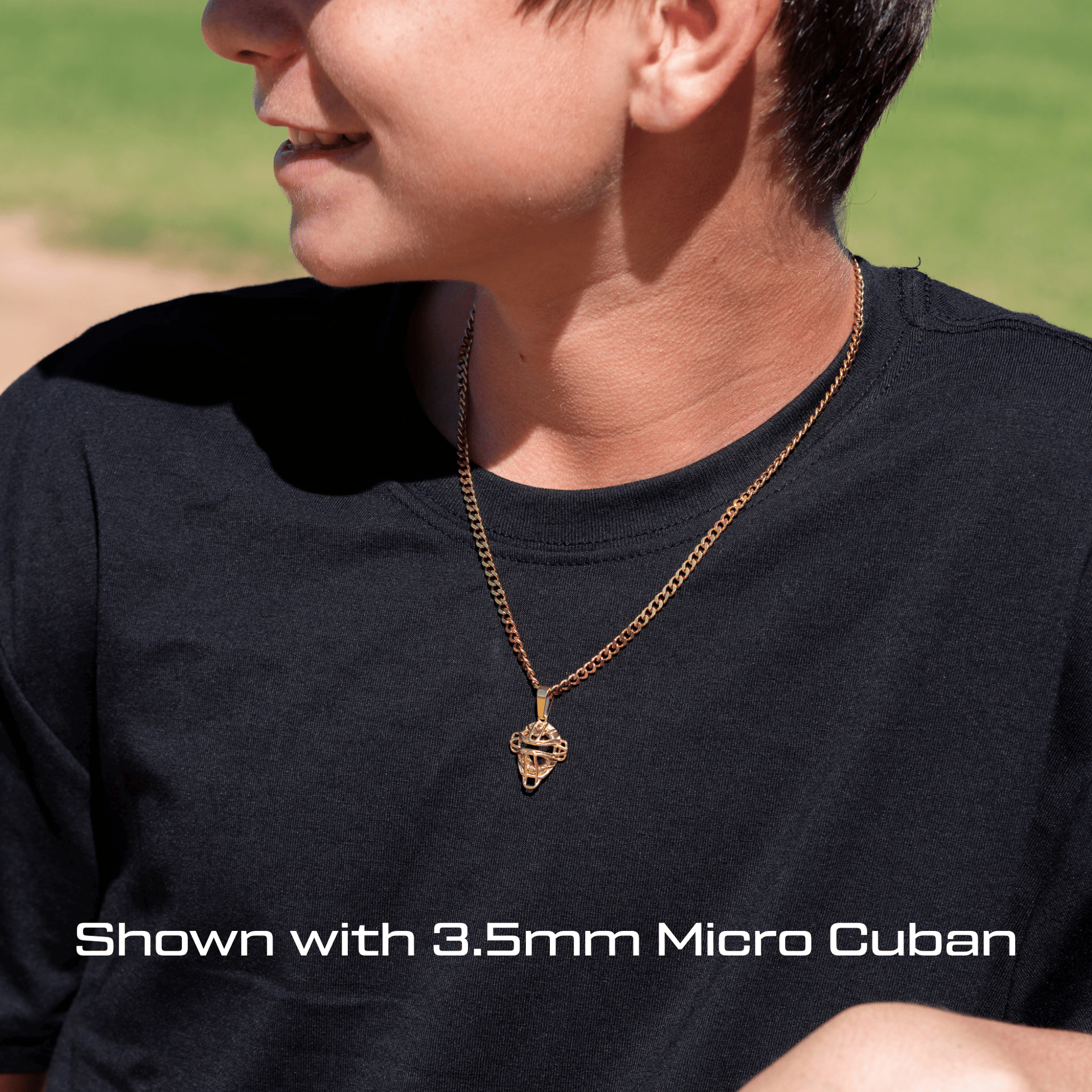 Person wearing a All In Faith Youth baseball catchers mask necklace in yellow gold stainless