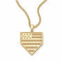 A gold baseball-shaped pendant necklace featuring an engraved American flag design with stars and stripes, suspended from a gold curb chain against a white background.