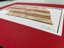 Nebraska Baseball Artwork - Made from Reclaimed Baseballs displayed on a red matting, showcasing the unique texture of baseballs.