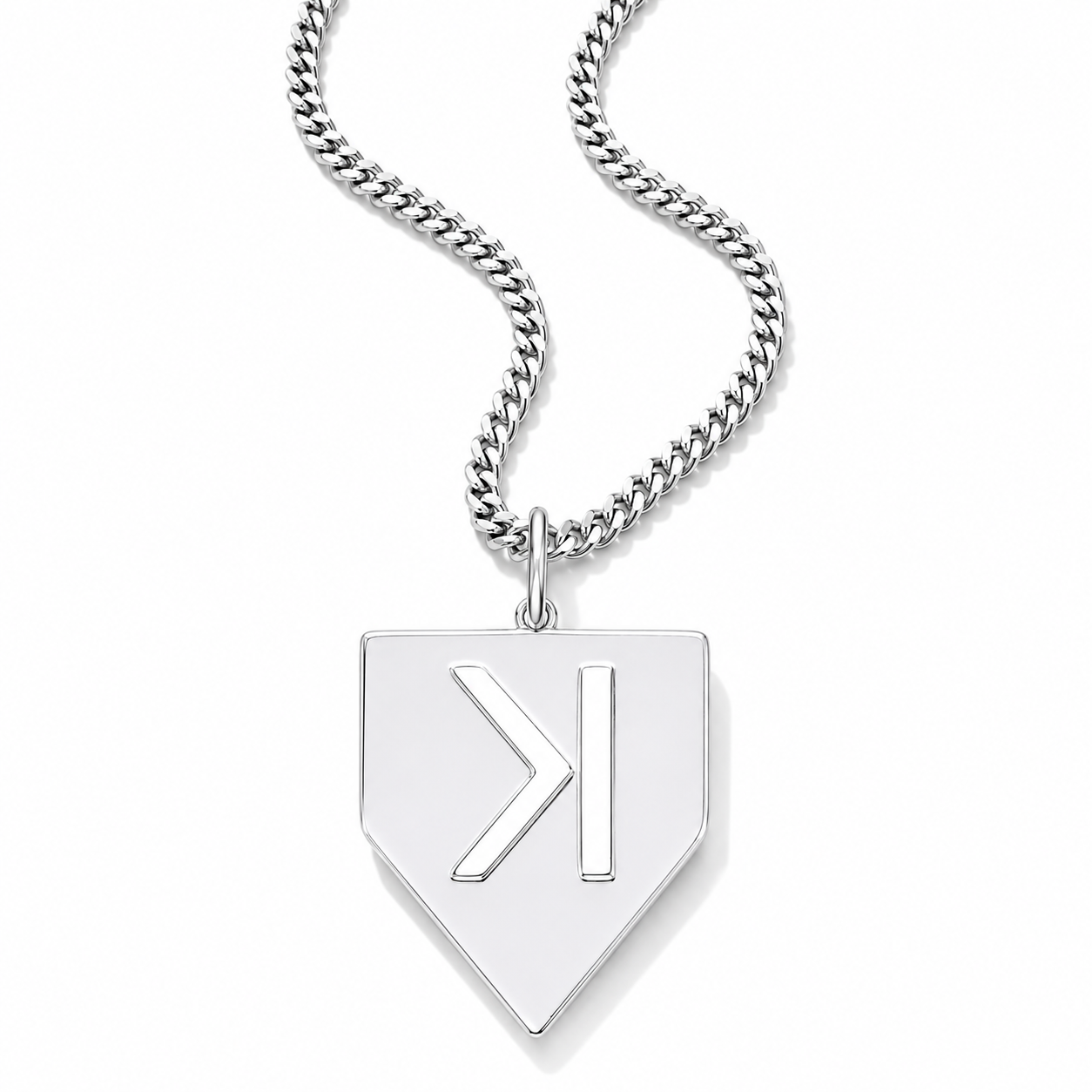 A silver pendant necklace featuring a shield-shaped pendant with a stylized 'K' monogram, suspended from a curb chain against a white background.