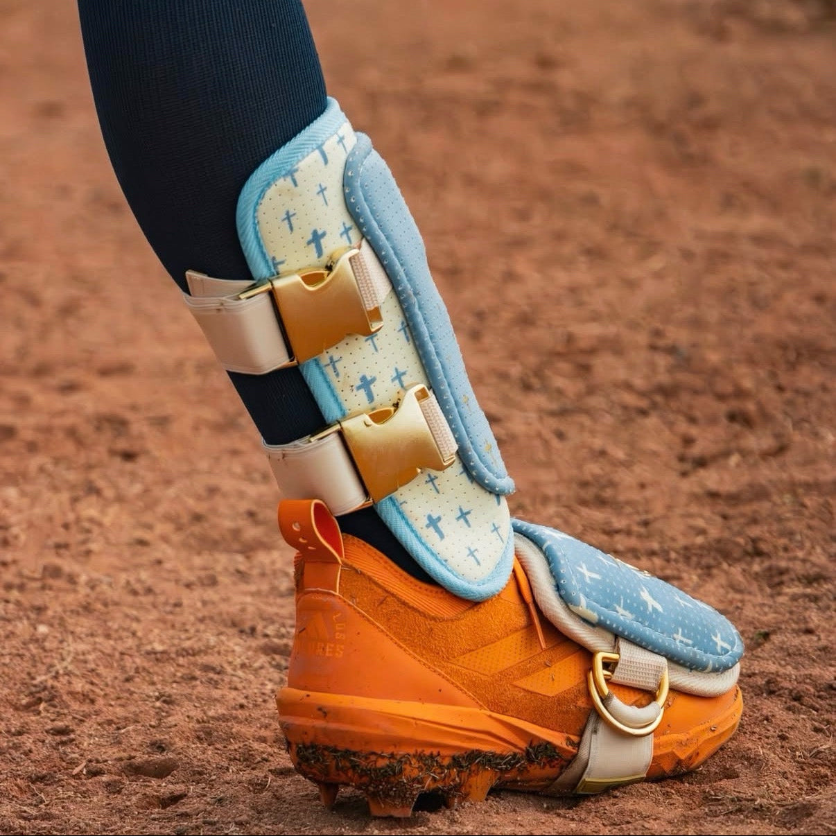 Psalm 23 baseball leg guard in blue and cream with gold cross accents, protective shin guard for hitters with faith-based design and toe guard included