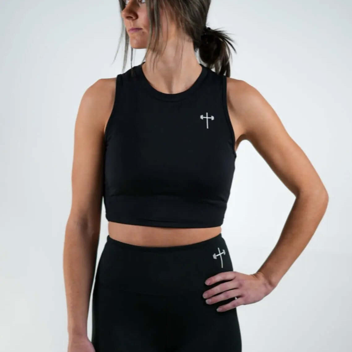HolStrength female model wearing a black Active Combat Christian workout top, front view