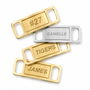 Four personalized belt buckle keychains arranged on a white background. Two are gold-toned with engraved names 'TIGERS' and 'JAMES', one is silver-toned with the name 'DANIELLE', and one is gold-toned with the number '#27'.