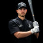 Jax Athletics Platinum White Baseball Gloves | Pro Cuff | Man holding a baseball bat wearing a black cap, hoodie, and gloves with 'JAX' branding on a black background.
