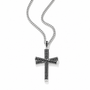 A silver-toned cross pendant necklace paved with small black stones, suspended from a silver curb chain against a clean white background.
