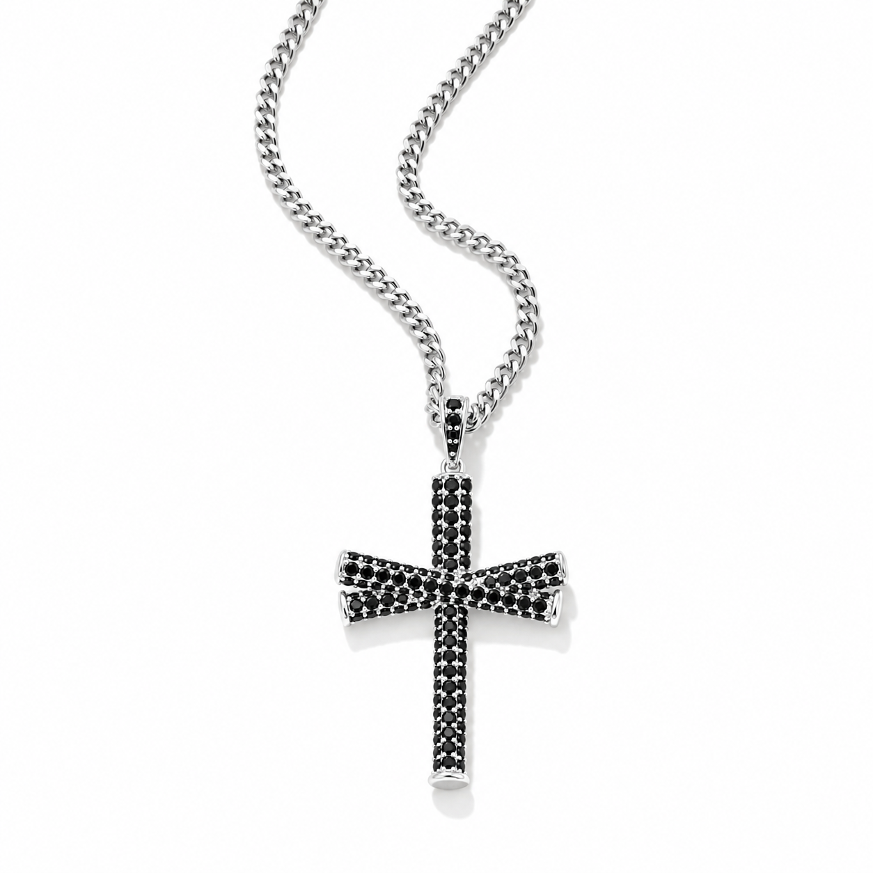 A silver-toned cross pendant necklace paved with small black stones, suspended from a silver curb chain against a clean white background.