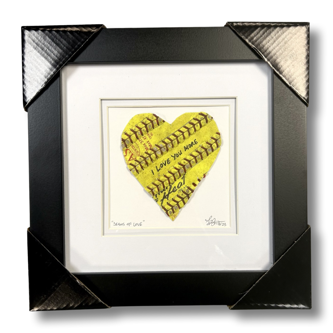 Softball Heart Artwork titled “Seams of Love” showcasing a heart-shaped design with a softball theme.