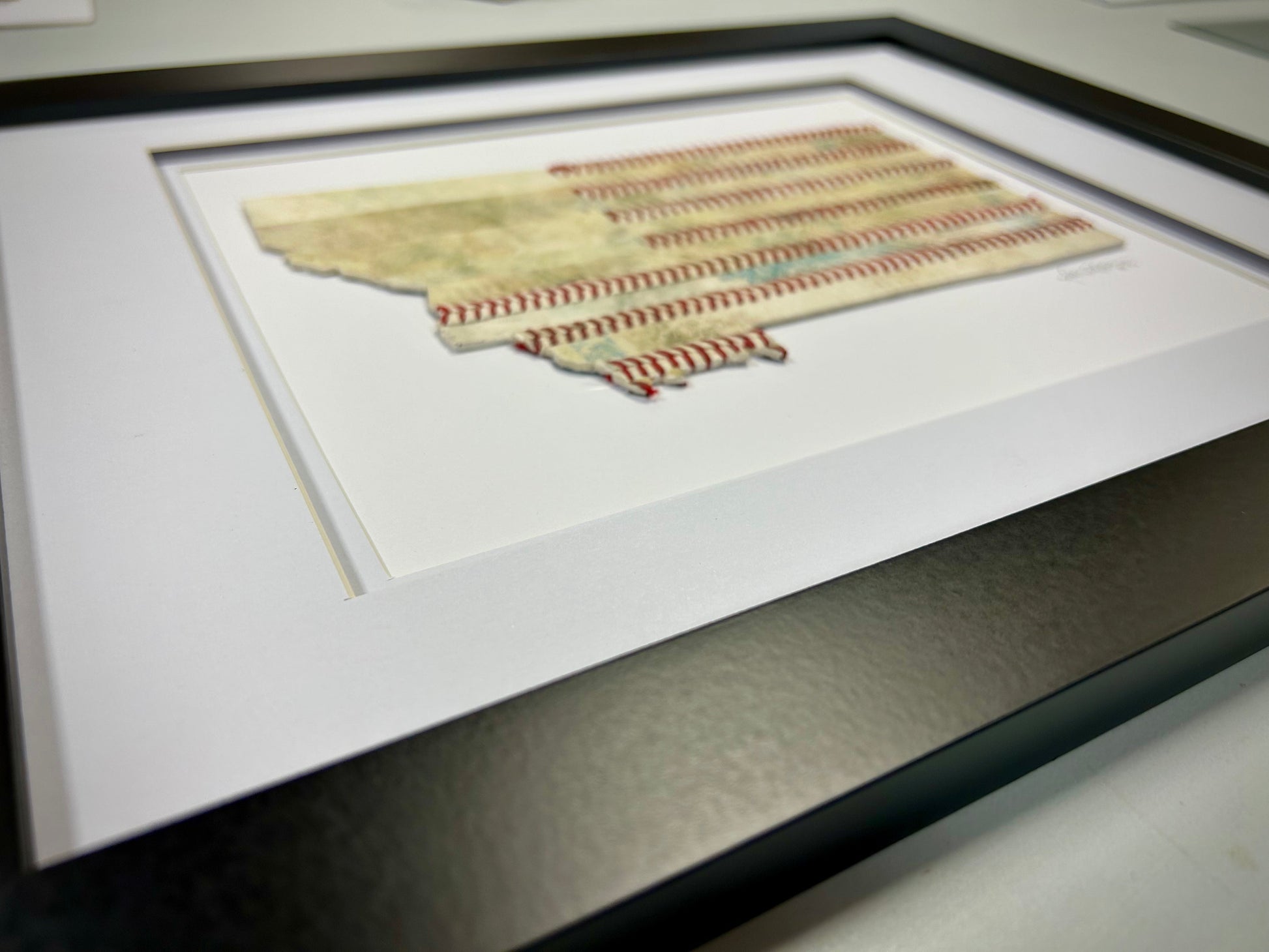 Montana Original Baseball Artwork - made from used baseballs displayed in a black frame.