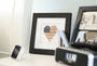 Framed "America's Love" Original Artwork showcasing a heart with American Flag design on a table.