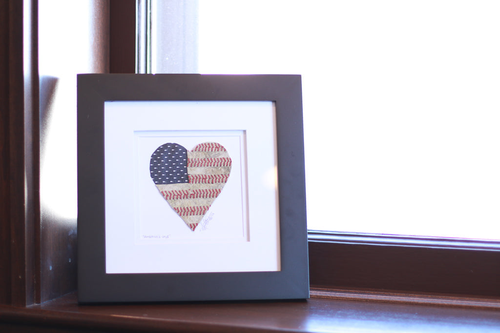 Framed artwork titled "America's Love" Original Artwork featuring a heart design with American flag and baseball patterns.