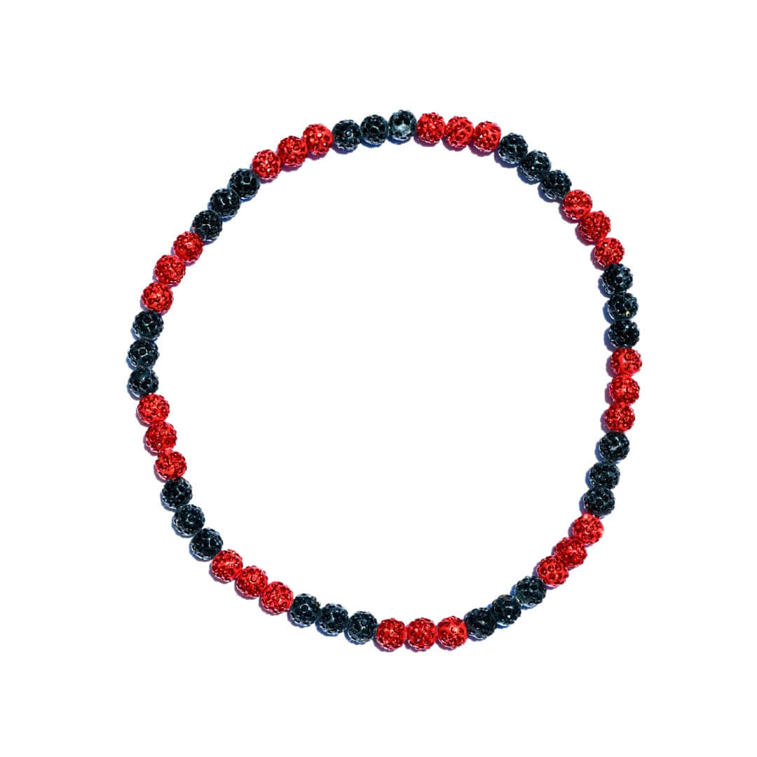 Beaded bracelet with red and black beads on a white background