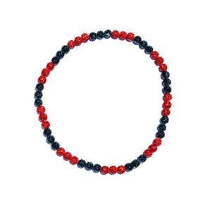 Beaded bracelet with red and black beads on a white background