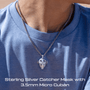 Person wearing a Iced out Sterling Silver Catcher Mask necklace with 3.5mm Micro Cuban chain on a blue shirt.