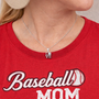 Baseball mom wearing an all in faith LOVE necklace pendant