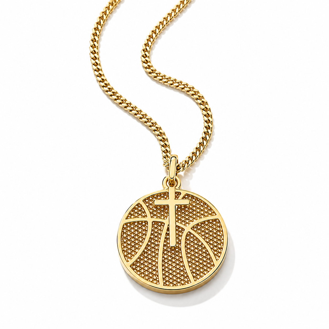 A gold pendant necklace featuring a basketball design with a cross in the center, suspended from a gold curb chain on a white background.