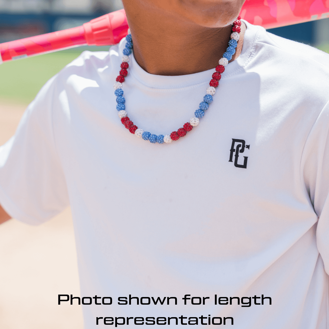 Person wearing a white shirt with a logo and a iced out red white and blue beaded necklace