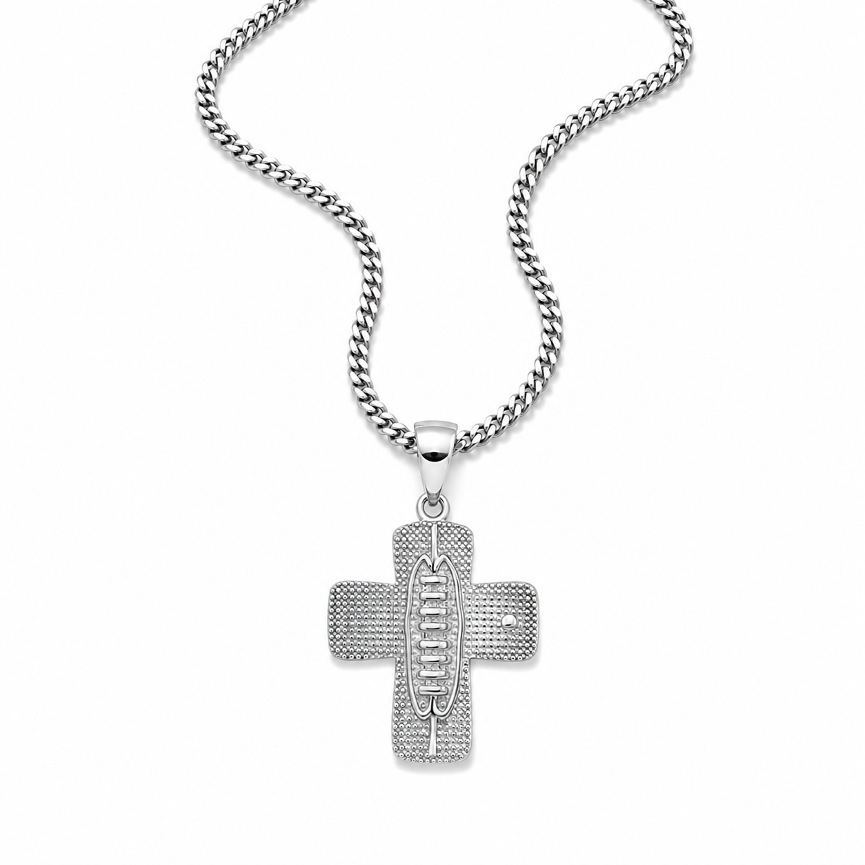 A silver cross pendant necklace with a textured, pave-set design and the word 'JESUS' in the center, hanging from a silver curb chain against a plain white background.