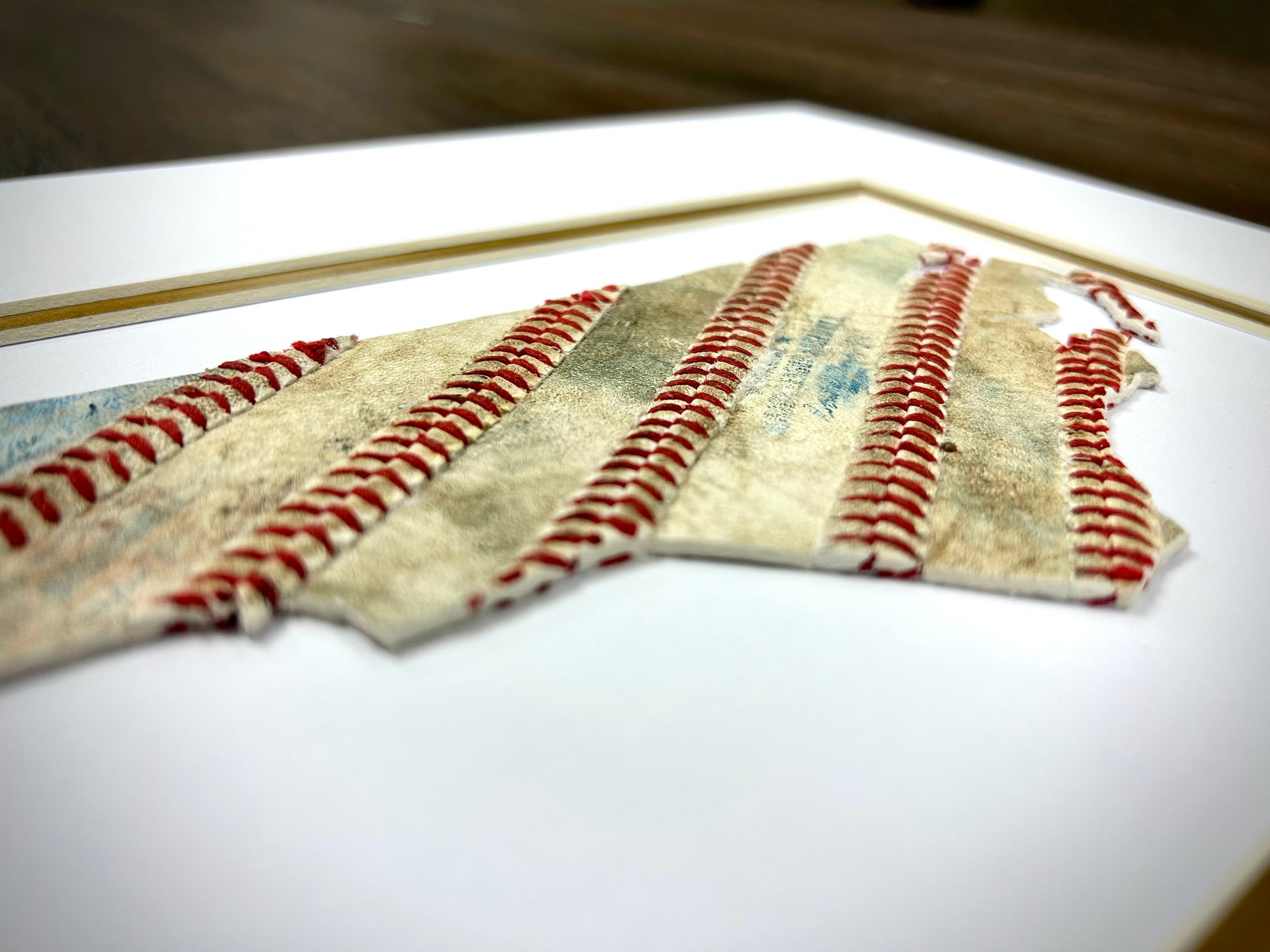 Custom State Artwork - North Carolina made from used baseballs, showcasing intricate stitching and textures.