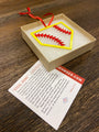 "STEEL HOME" Softball Christmas Ornament displayed in a gift box with a card detailing its origin.