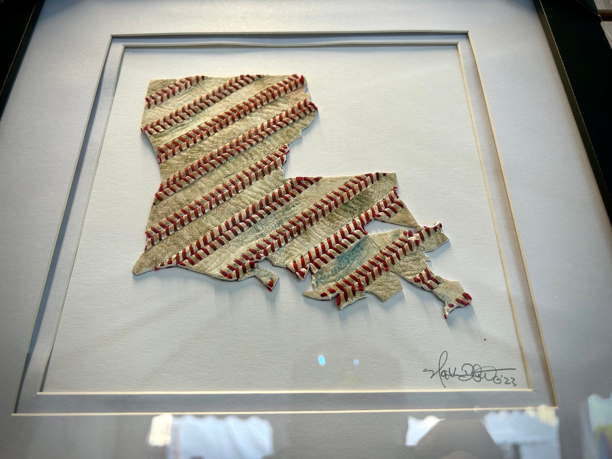 Custom State Artwork - Louisiana made from used baseballs, featuring a handcrafted baseball art piece in a framed design.