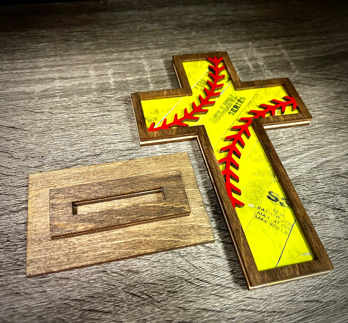 The Baseball Seams Company Old Rugged baseball and softball cross with wooden display stand