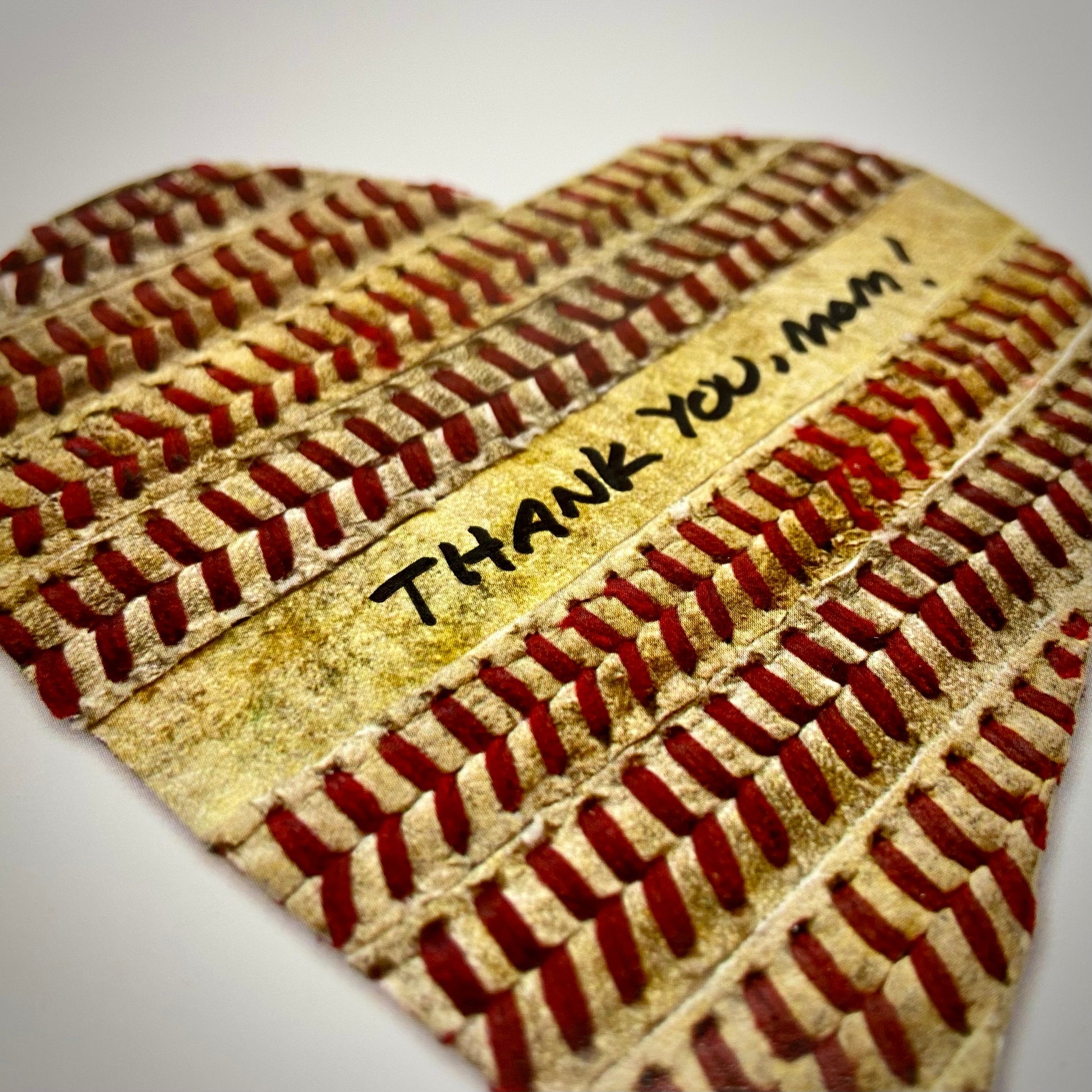 Customizable Baseball Heart Print in 10x10 White Matting featuring a heart design made of baseball stitching and the phrase 'THANK YOU, MOM!'