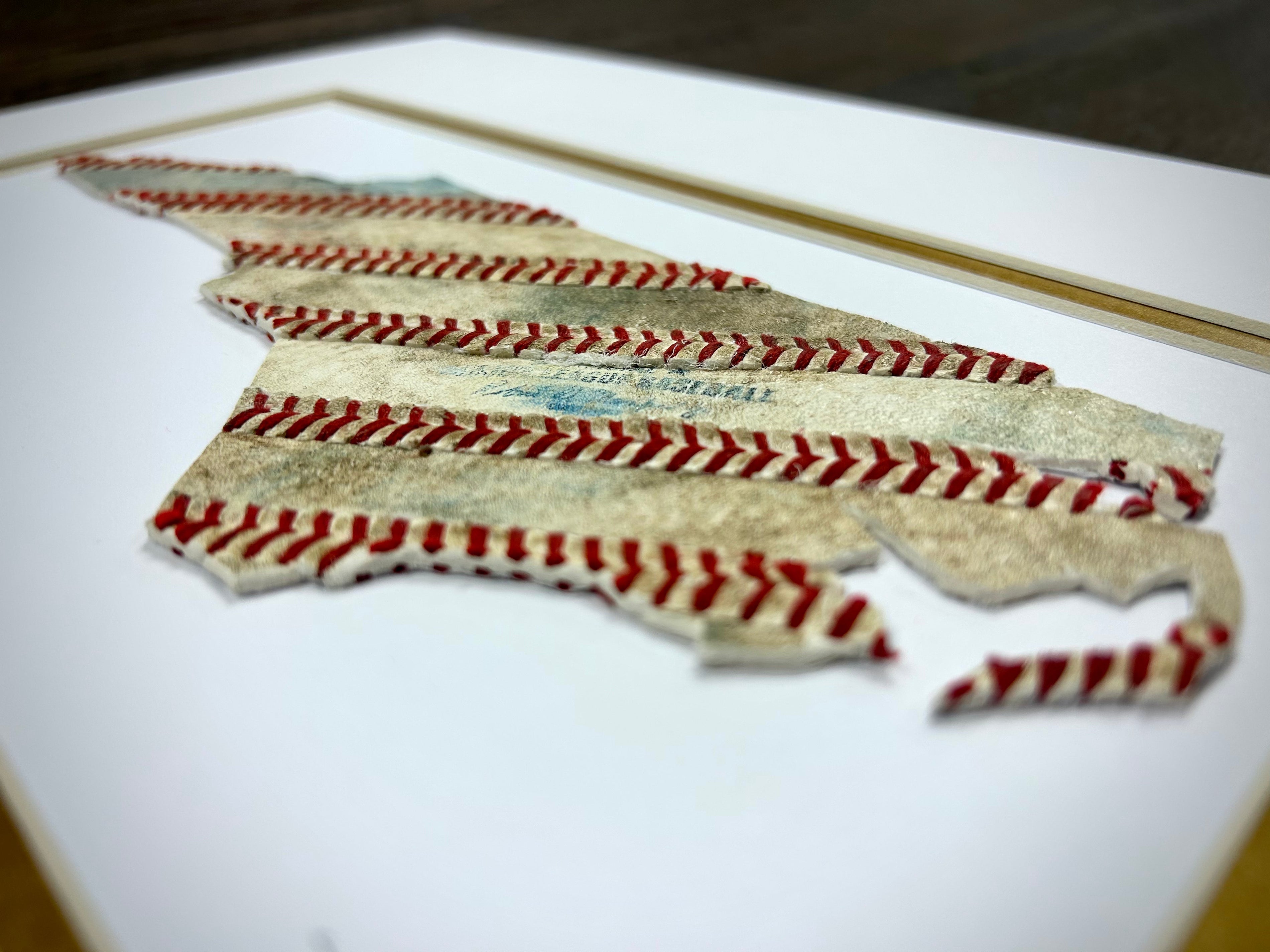 Custom State Artwork - North Carolina made from used baseballs featuring stitched baseball seams.