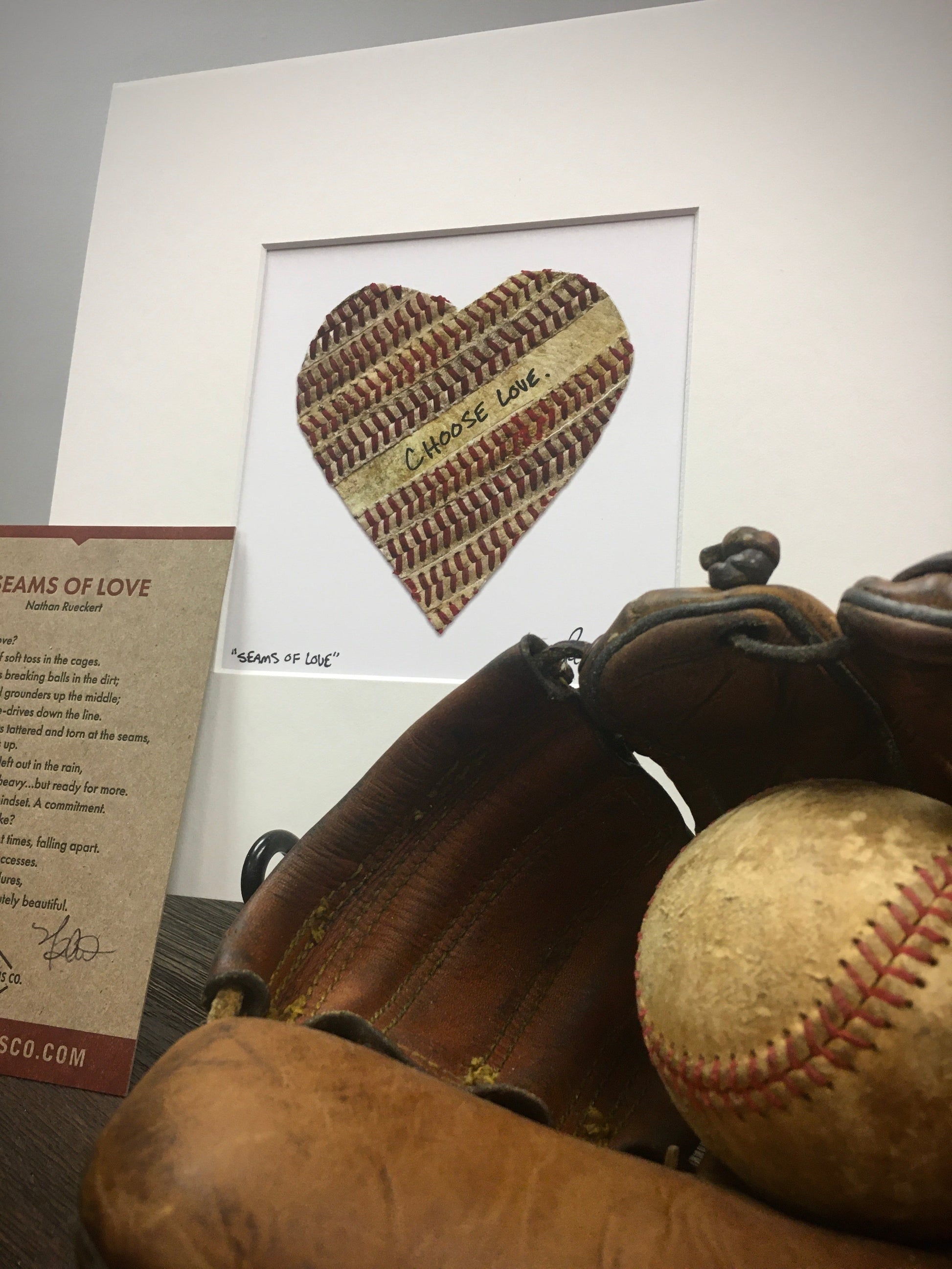 Customizable Baseball Heart Print in 10x10 White Matting featuring a heart made from baseball leather.