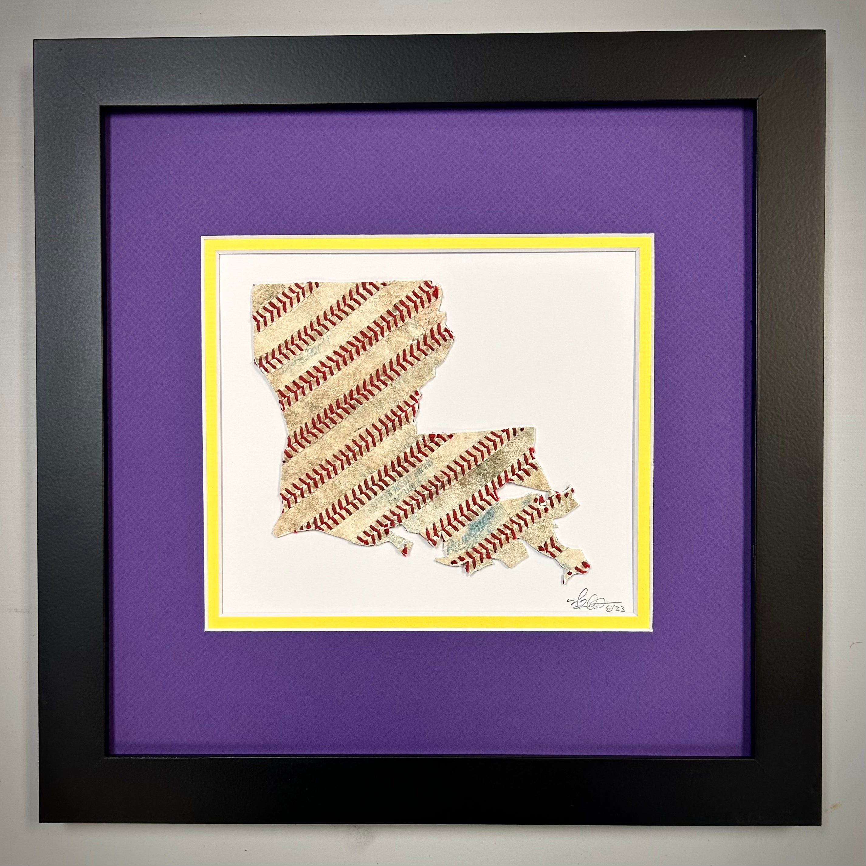 Custom State Artwork - Louisiana made from used baseballs, framed in purple and yellow, showcasing unique baseball stitching.