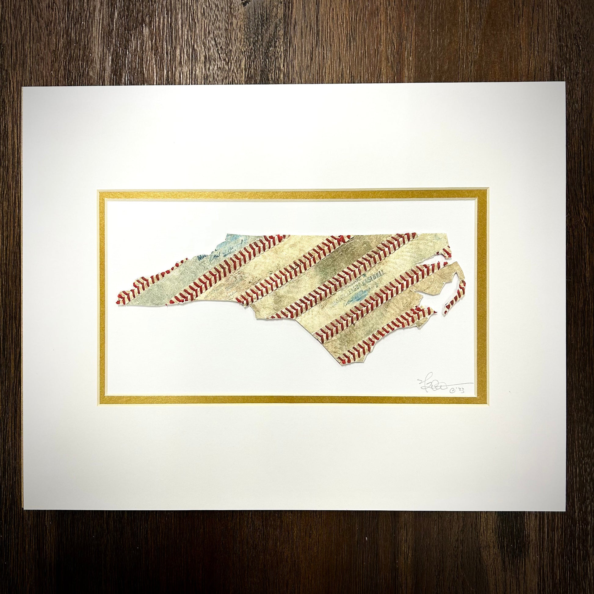 Custom State Artwork - North Carolina made from used baseballs, handcrafted art piece, vibrant design, framed.