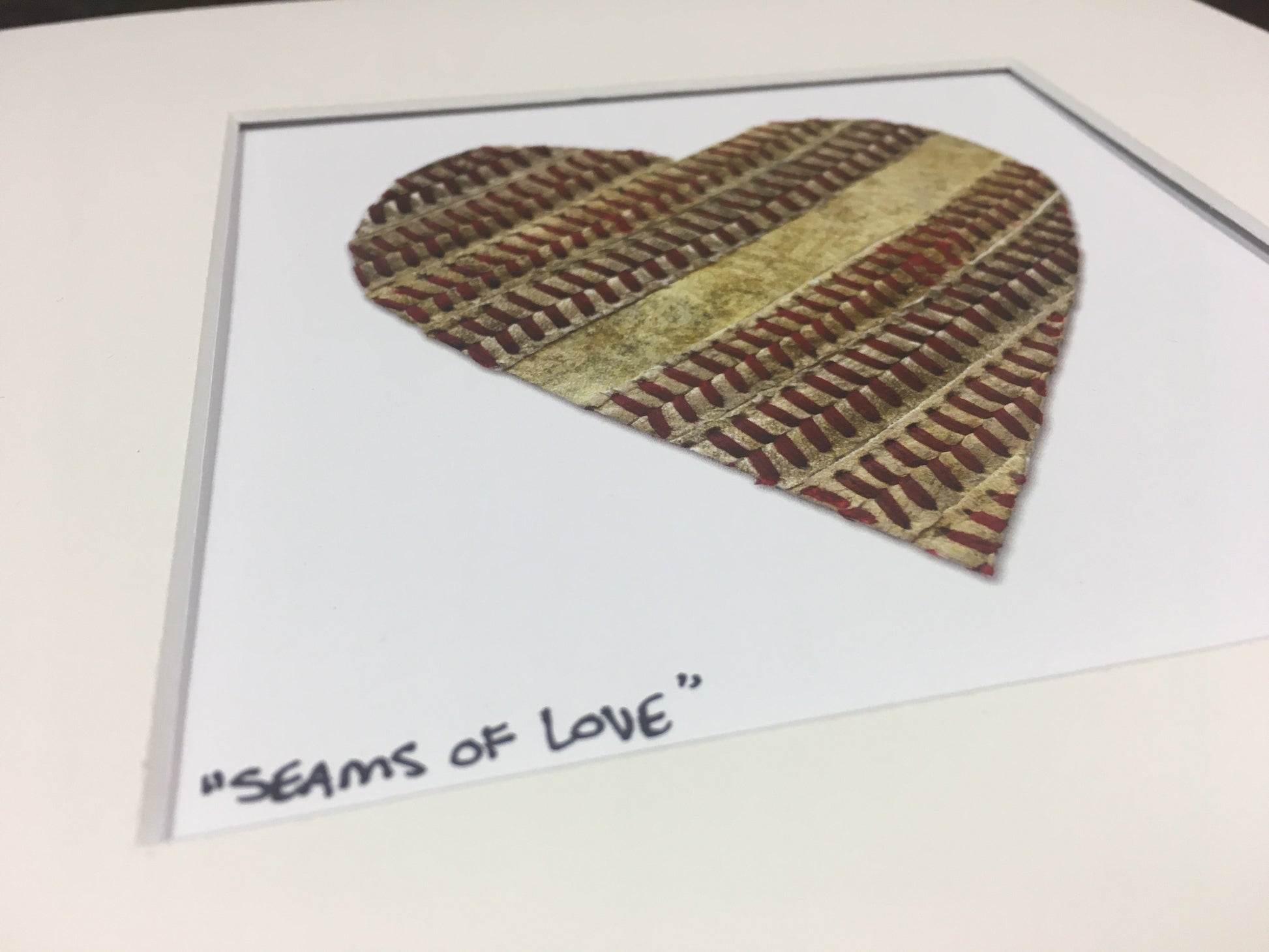 Customizable Baseball Heart Print in 10x10 White Matting featuring a heart design made of baseball seams.