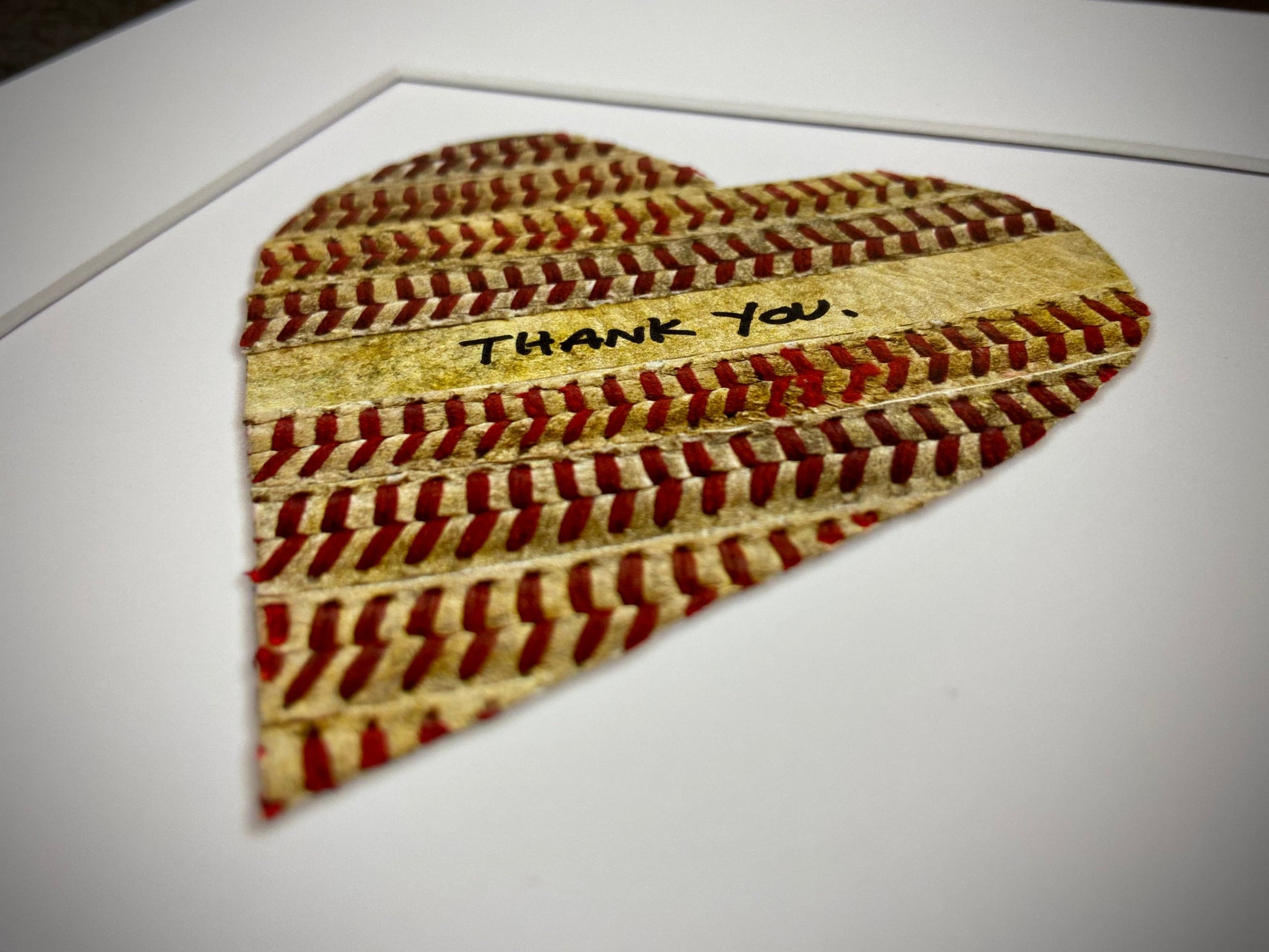 Customizable Baseball Heart Print in 10x10 White Matting featuring a heart made from baseball stitching with a thank you inscription.