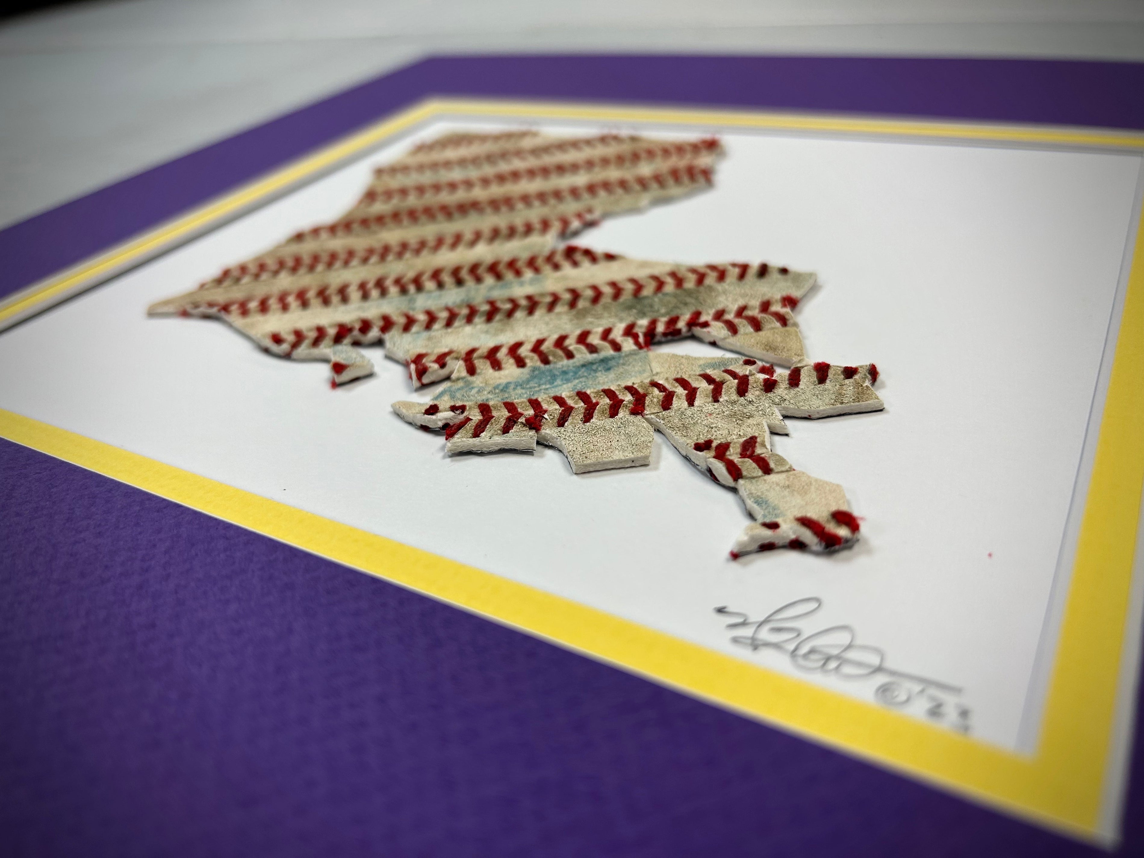 Custom State Artwork - Louisiana made from used baseballs, featuring a unique design with baseball stitching on a colorful mat.