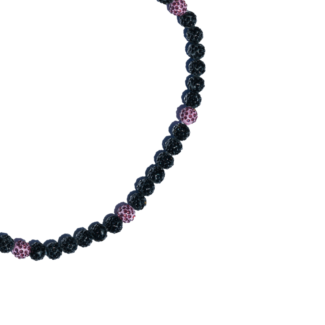 Necklace with black and pink beaded design on a white background