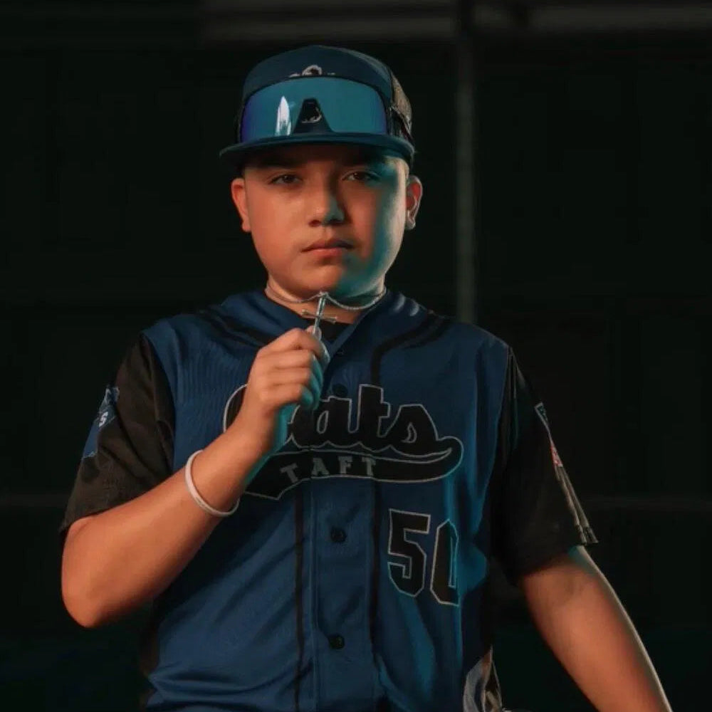 Original Baseball Bat Cross | A baseball player wearing a dark blue and black jersey with 'Rams' and the number 51, a matching cap, and holding a glove, set against a dark background.