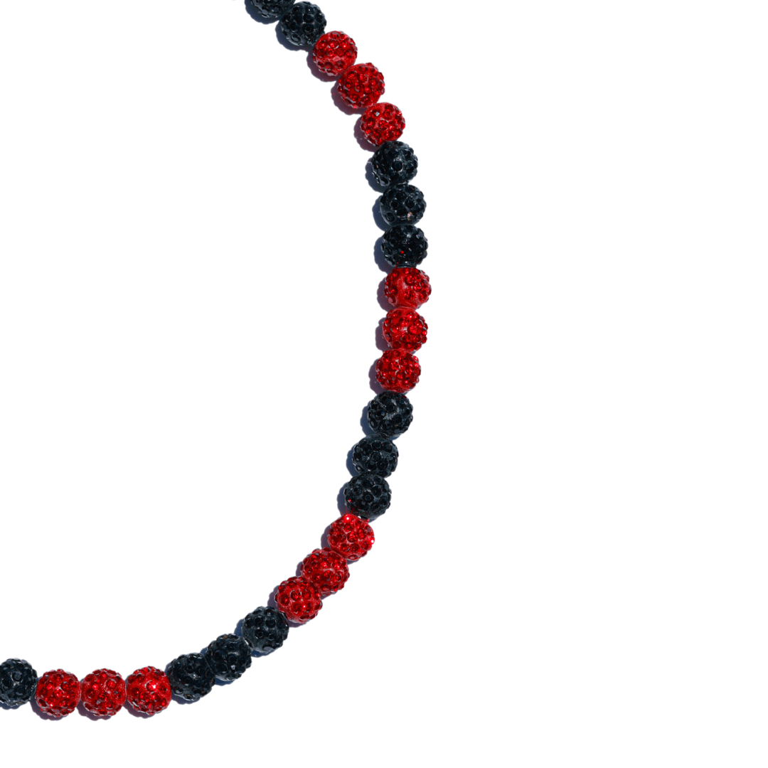 Necklace with red and black beads on a white background