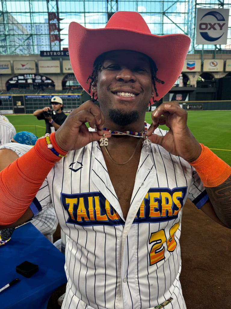 Taj Porter from the Texas Tailgators wearing the All In Faith Iced Out Catchers Mask Neckace